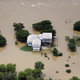 Flood waters from the Brazos River surround a home in Weatherford, Texas on Friday, May 29th. Image: Brandon Wade/AP